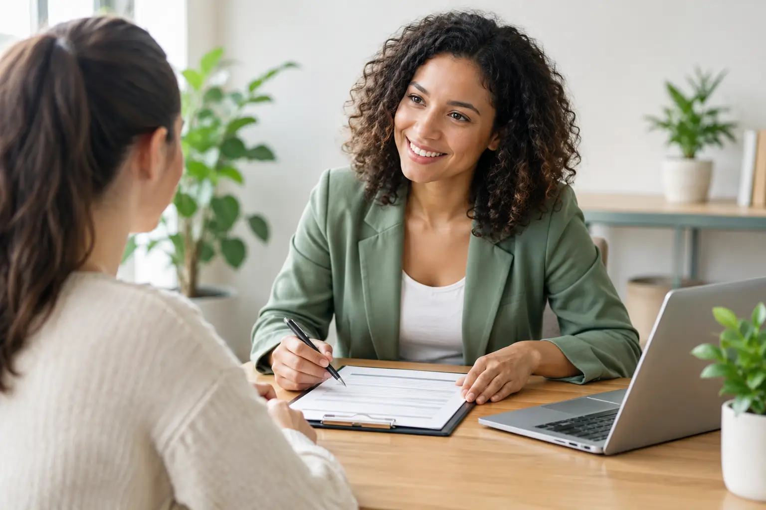 Service business owner reviewing a customer intake form with a client